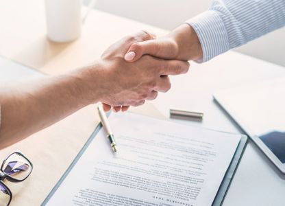 A handshake happening in a meeting
