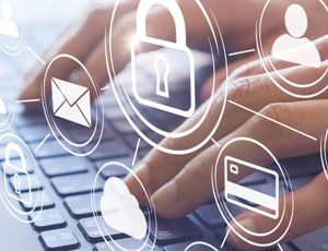 A person typing on their laptop with a digital graphic overlay