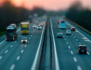 Vehicles travelling on a multi‑lane motorway at dusk