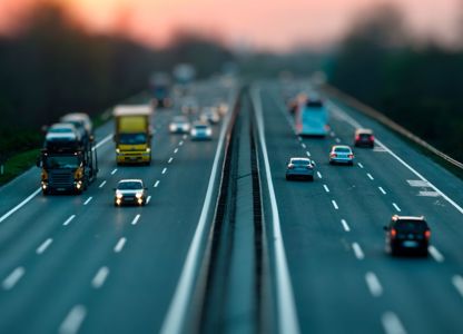 Vehicles travelling on a multi‑lane motorway at dusk