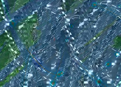 Aerial view of a motorway interchange, overlaid with glowing digital network lines