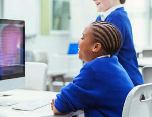 students learning and looking at a computer