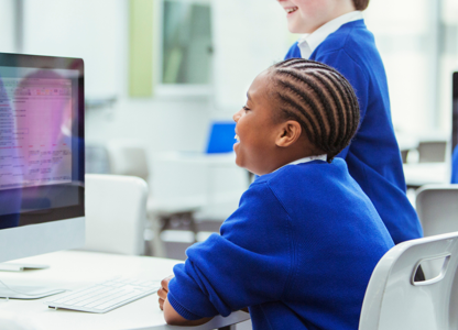 students learning and looking at a computer