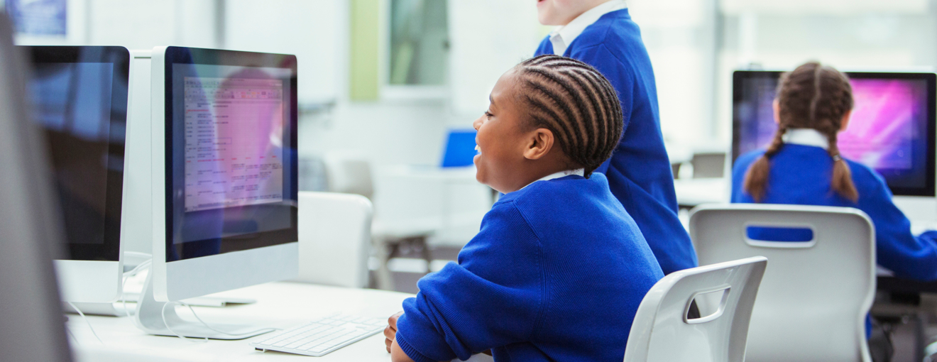 students learning and looking at a computer