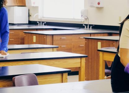 cleaners cleaning desks in a school