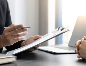 Two individuals seated at a desk
