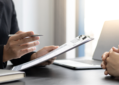 Two individuals seated at a desk