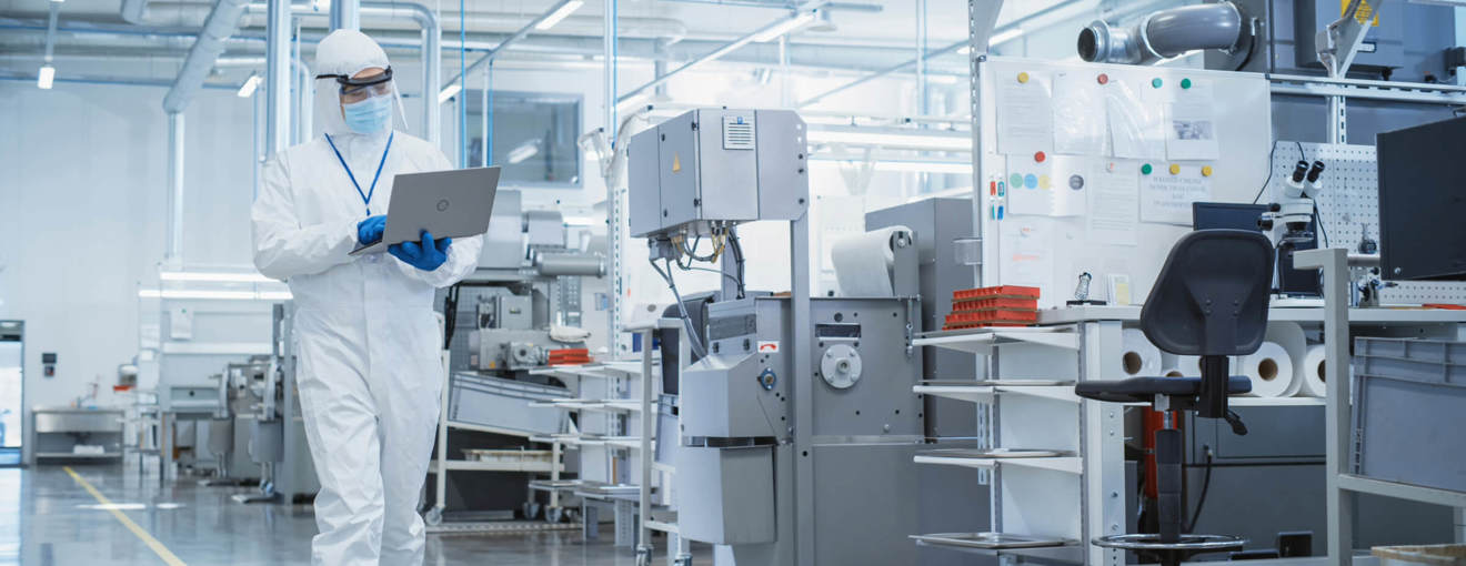 A person wearing PPE in a lab