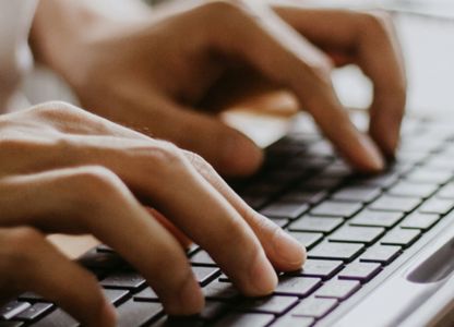 Person typing on a keyboard