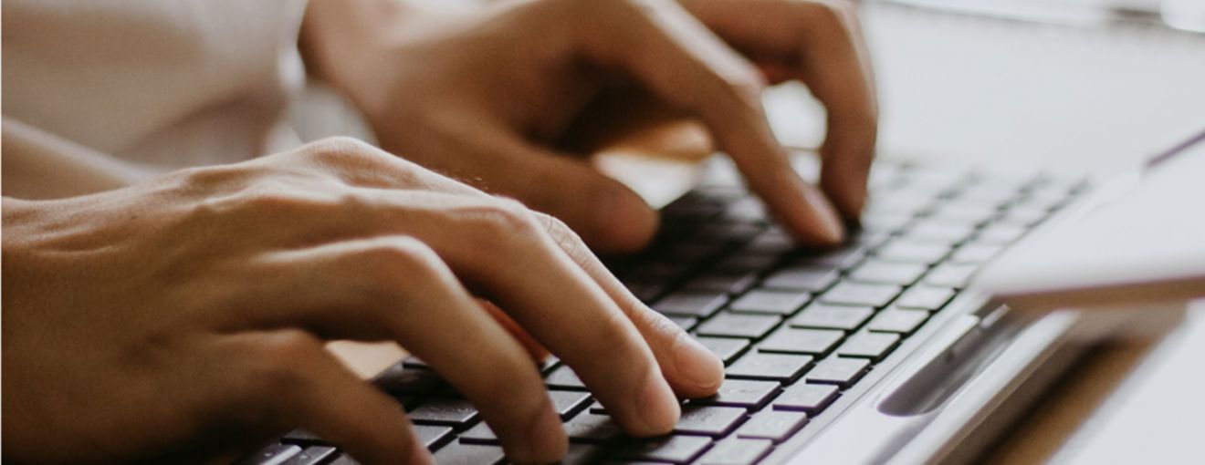 Person typing on a keyboard