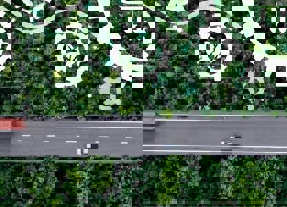 Road through a remote landscape with a technology graphic overlay