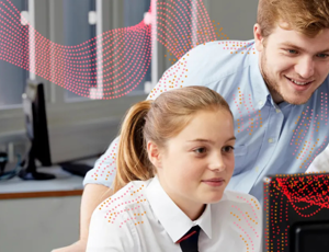 Teacher and pupil looking at a computer