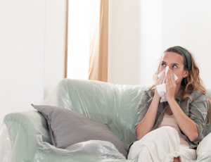 A person sat on the sofa with black mould
