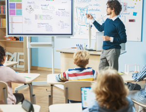 A teacher in a classroom in front of students