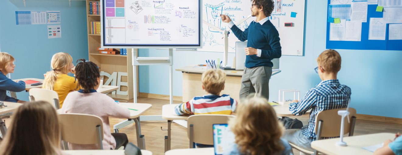 A teacher in a classroom in front of students